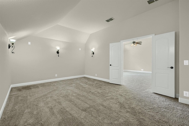 spare room featuring lofted ceiling and carpet flooring