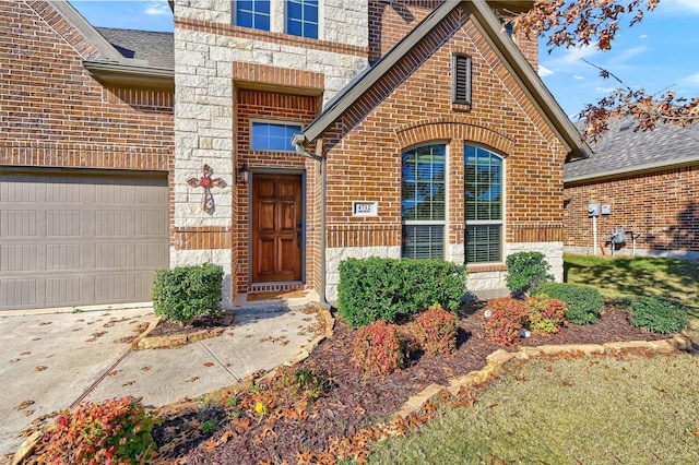 doorway to property with a garage