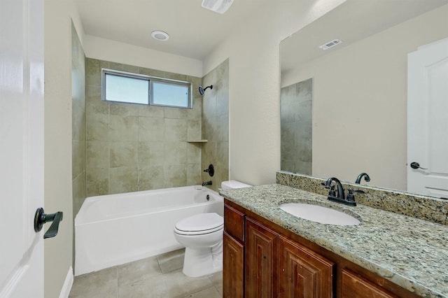 full bathroom with tiled shower / bath combo, vanity, tile patterned floors, and toilet