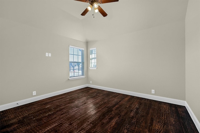 spare room featuring hardwood / wood-style flooring, vaulted ceiling, and ceiling fan