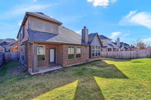 back of house featuring a patio and a lawn