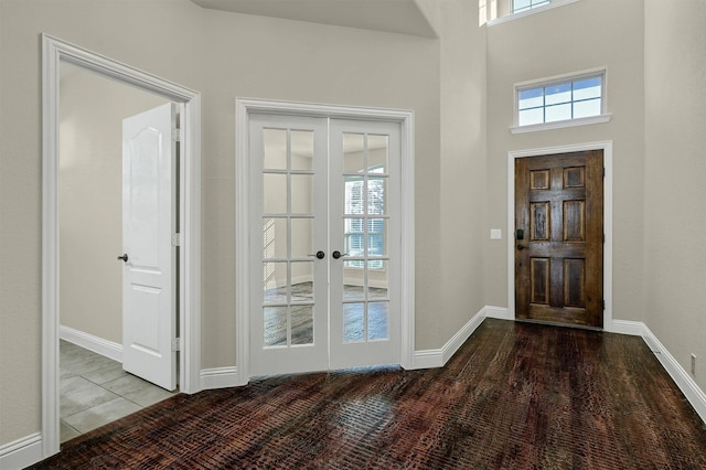 foyer entrance featuring french doors and a high ceiling