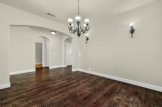 unfurnished dining area with dark hardwood / wood-style floors and a chandelier