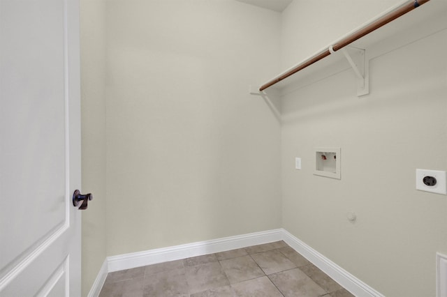 clothes washing area featuring gas dryer hookup, electric dryer hookup, washer hookup, and light tile patterned floors