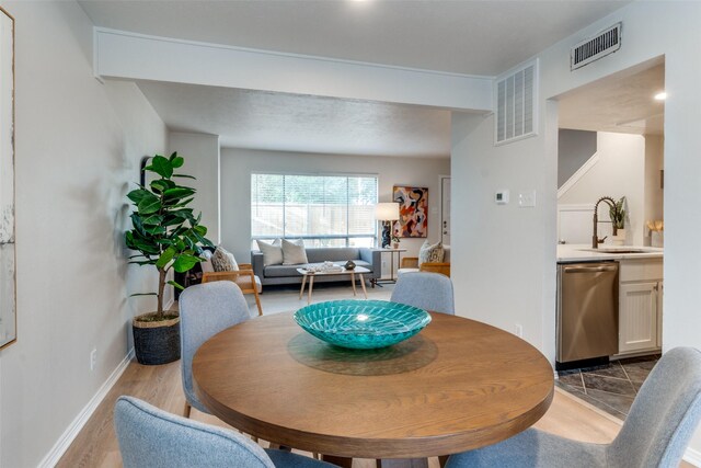 dining area featuring light wood-type flooring