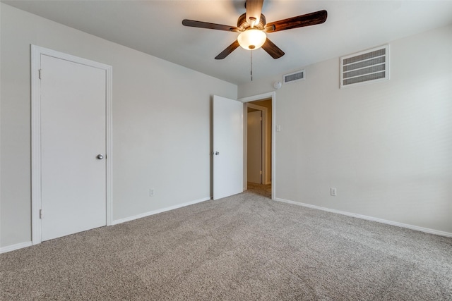 carpeted empty room featuring ceiling fan