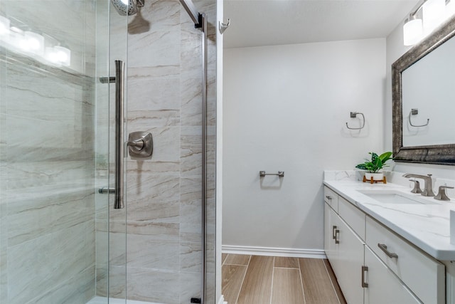 bathroom with vanity and a shower with shower door