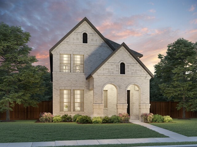 french country style house featuring a lawn