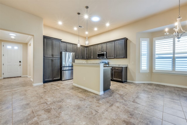 kitchen with stainless steel appliances, dark brown cabinetry, a kitchen island, decorative light fixtures, and a chandelier