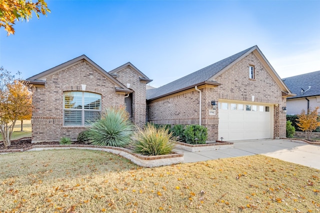 view of front of house featuring a front yard and a garage