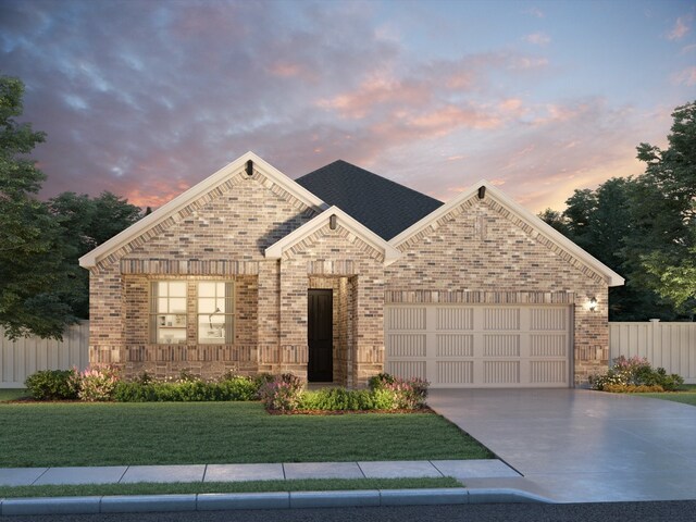 view of front facade with a yard and a garage