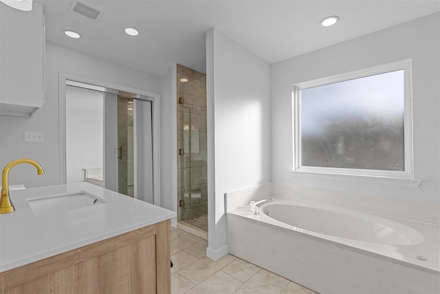 full bathroom featuring a garden tub, visible vents, a stall shower, vanity, and tile patterned flooring