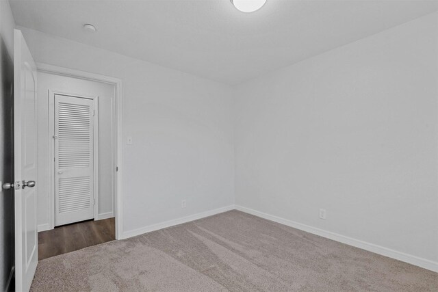 empty room featuring dark colored carpet