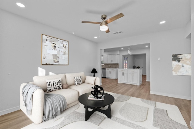 living room featuring recessed lighting, visible vents, and light wood finished floors