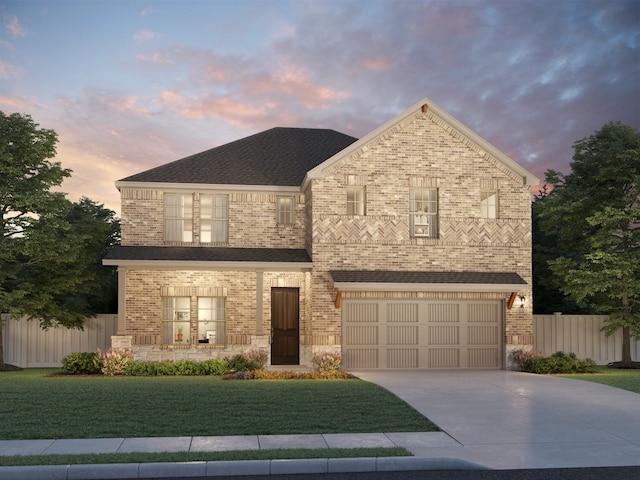 view of front of property with a yard and a garage