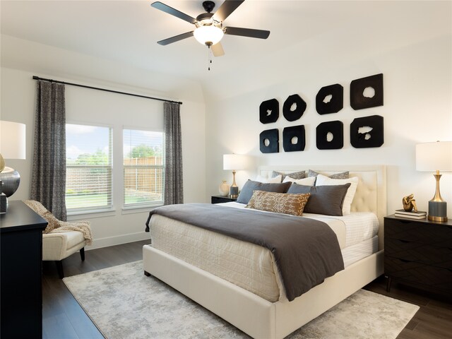 bedroom with ceiling fan and dark wood-type flooring