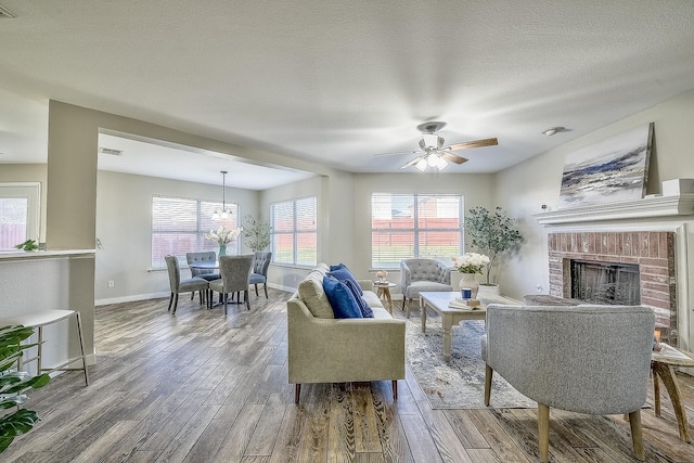 living room with hardwood / wood-style flooring, a fireplace, and a wealth of natural light