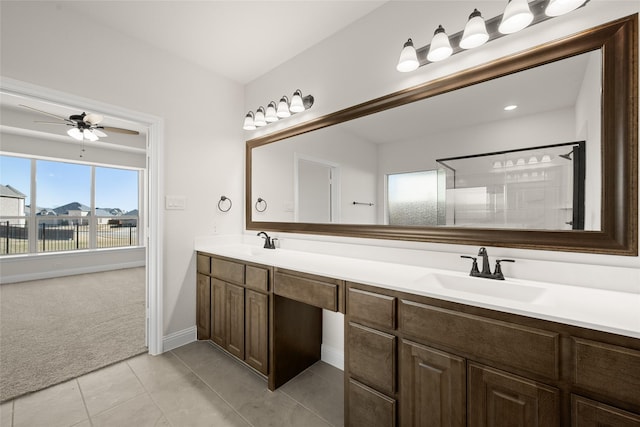 bathroom with tile patterned floors, ceiling fan, vanity, and walk in shower