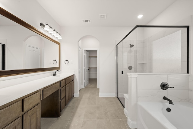 bathroom featuring tile patterned floors, vanity, and plus walk in shower