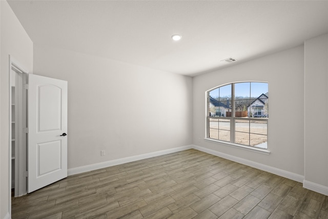 spare room featuring hardwood / wood-style flooring