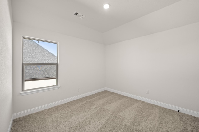 spare room featuring baseboards, plenty of natural light, carpet, and visible vents