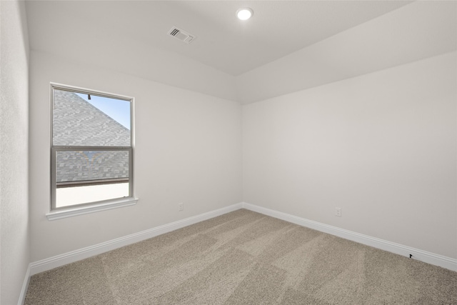 carpeted empty room featuring a wealth of natural light