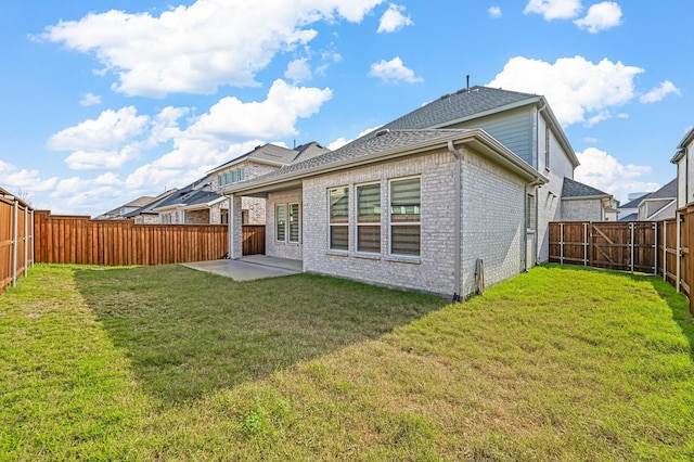 back of property with a patio and a yard