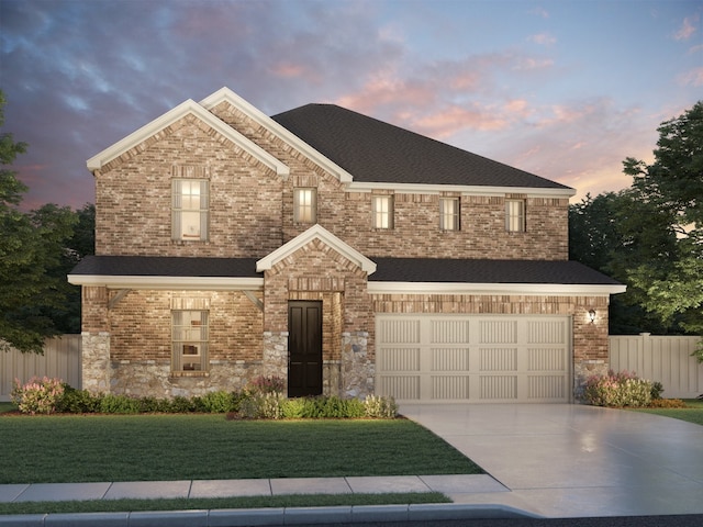 view of front of property with a garage and a lawn