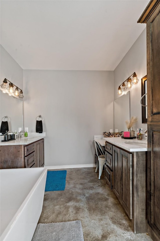 bathroom with vanity, concrete flooring, and a washtub