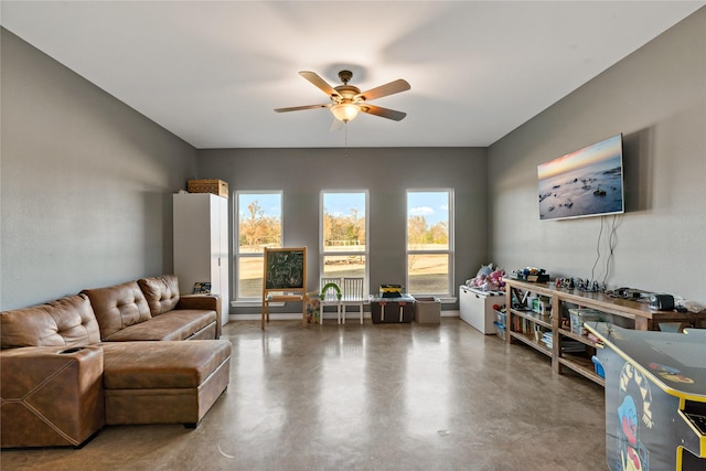 living room featuring concrete flooring and ceiling fan