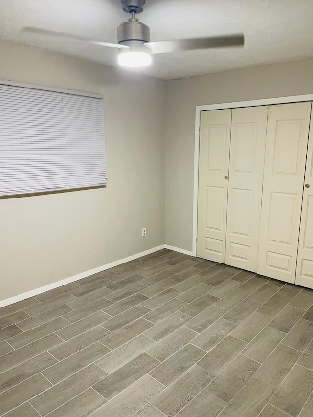 unfurnished bedroom featuring a closet, dark hardwood / wood-style floors, and ceiling fan