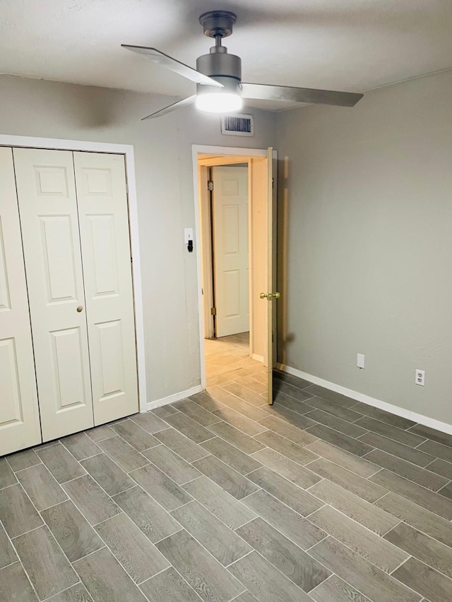 unfurnished bedroom with hardwood / wood-style flooring, ceiling fan, and a closet