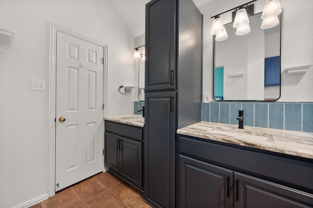 bathroom with vanity, tile patterned flooring, and decorative backsplash