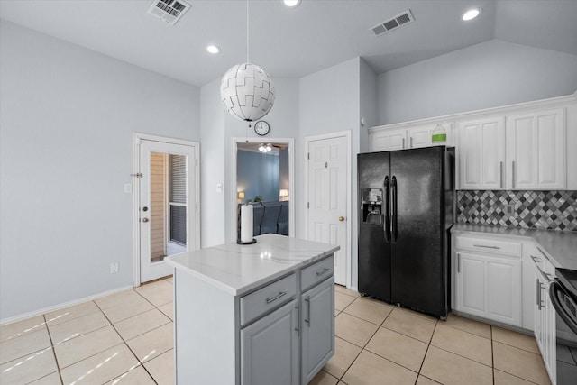 kitchen featuring a center island, white cabinets, light tile patterned flooring, and black appliances