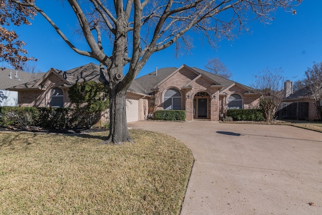 view of front facade with a front yard and a garage