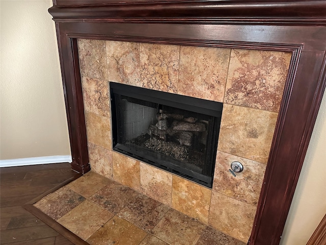 interior details featuring a tiled fireplace