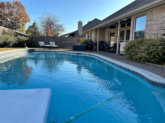 view of swimming pool featuring a patio and ceiling fan