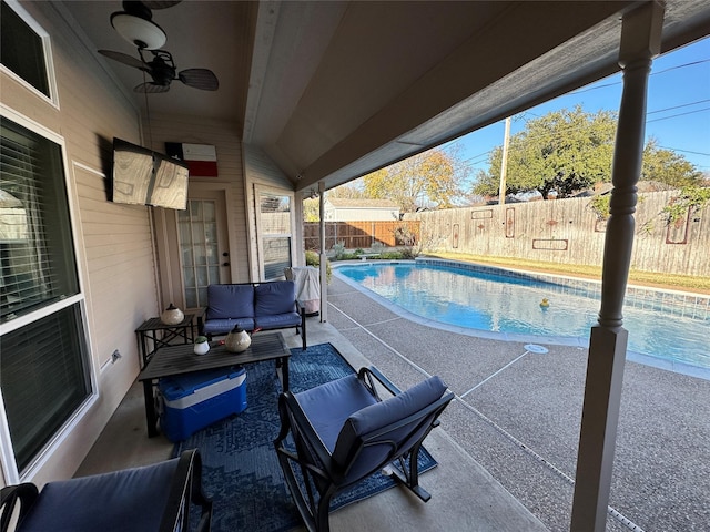 view of swimming pool with an outdoor living space, ceiling fan, and a patio