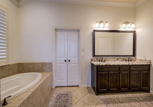 bathroom featuring ornamental molding, tile patterned flooring, tiled tub, and vanity