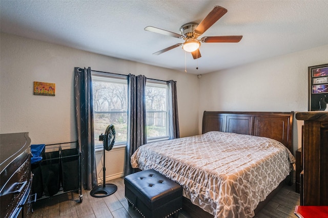 bedroom with wood-type flooring, a textured ceiling, and ceiling fan