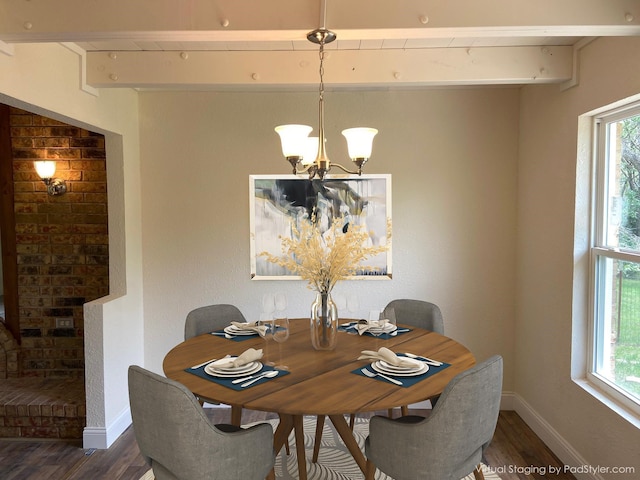 dining space featuring dark hardwood / wood-style flooring and an inviting chandelier