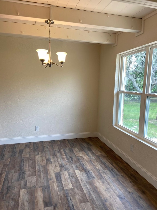 empty room with dark wood-type flooring and a notable chandelier