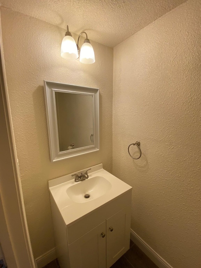 bathroom with vanity and a textured ceiling