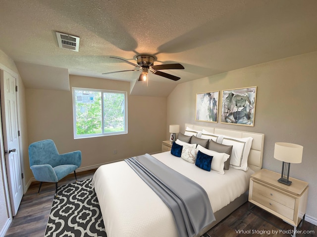 bedroom featuring a textured ceiling, dark hardwood / wood-style flooring, vaulted ceiling, and ceiling fan