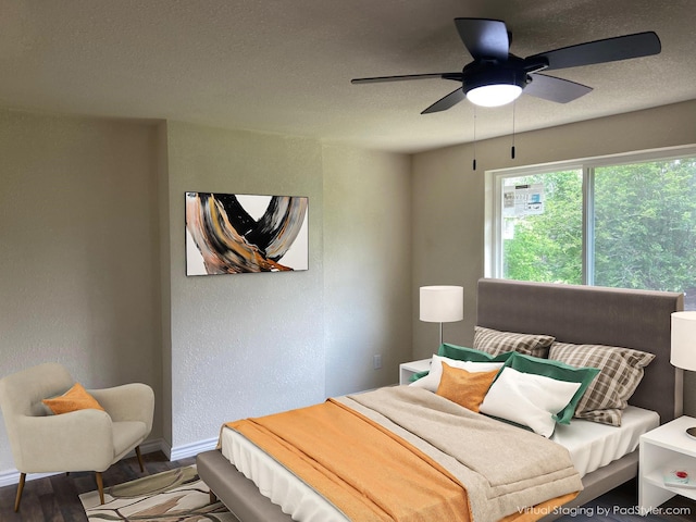 bedroom featuring ceiling fan, hardwood / wood-style floors, and a textured ceiling