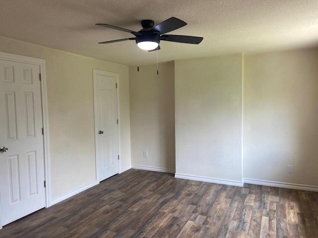 unfurnished bedroom featuring ceiling fan, a textured ceiling, and dark hardwood / wood-style flooring