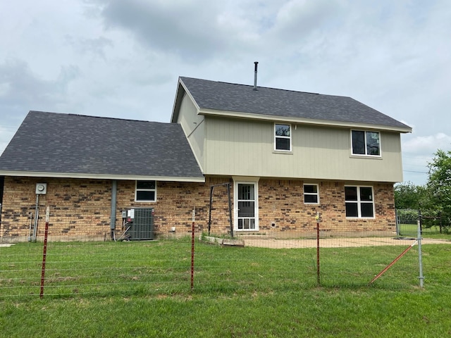 back of property featuring central air condition unit, a patio area, and a lawn