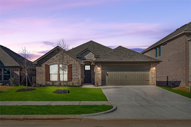 view of front of house with a yard and a garage