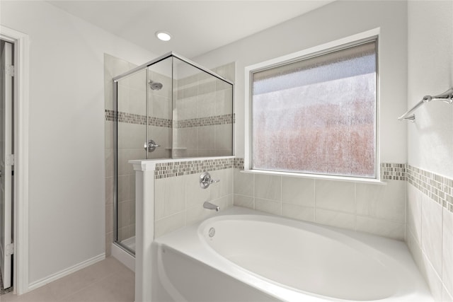 bathroom featuring tile patterned flooring and separate shower and tub