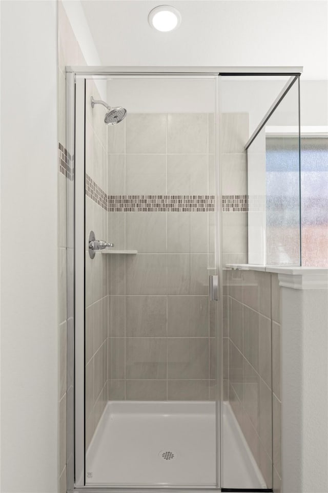 bathroom featuring an enclosed shower